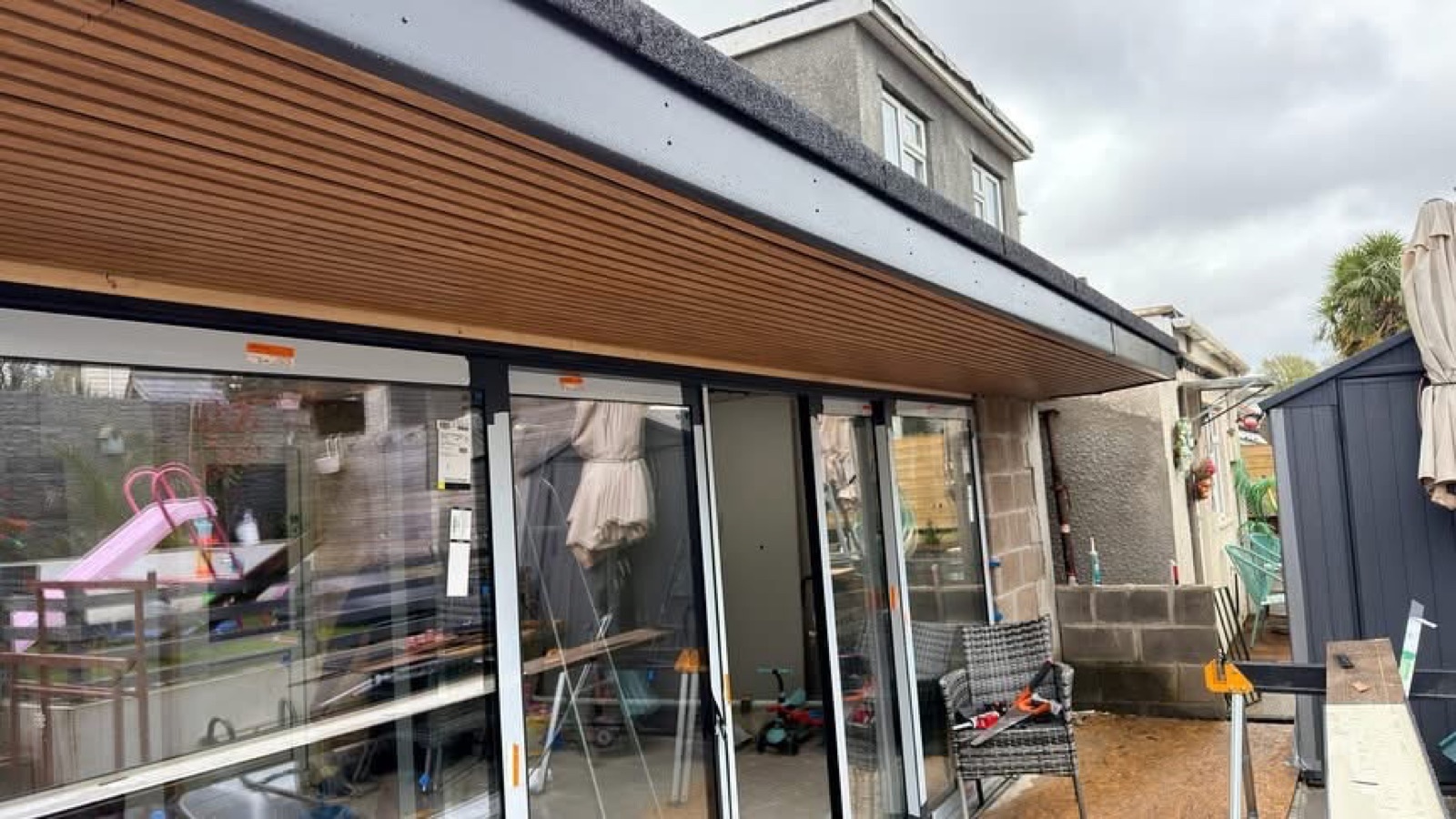 Timber slatted soffit above glazed doors