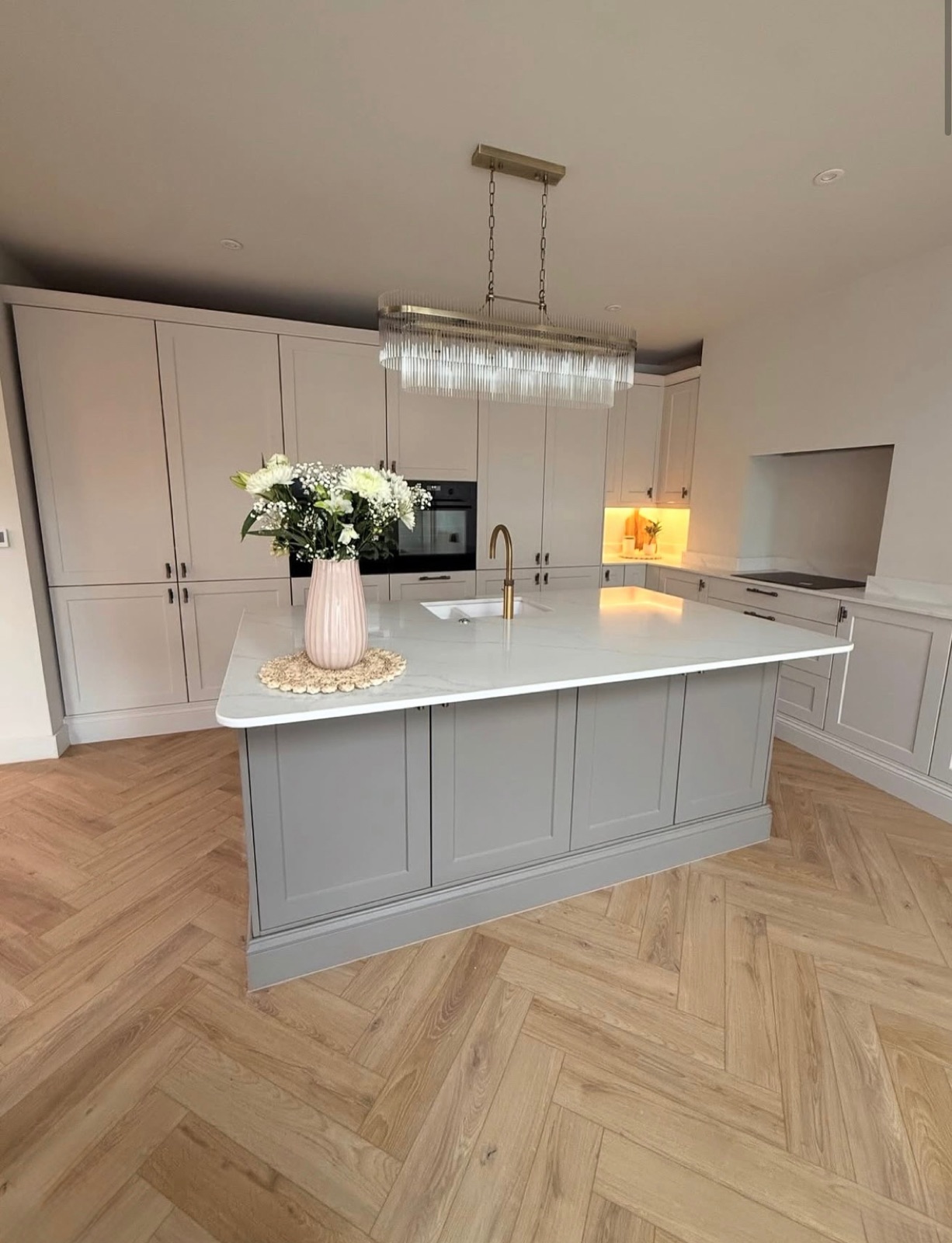Shaker kitchen with an island and herringbone flooring