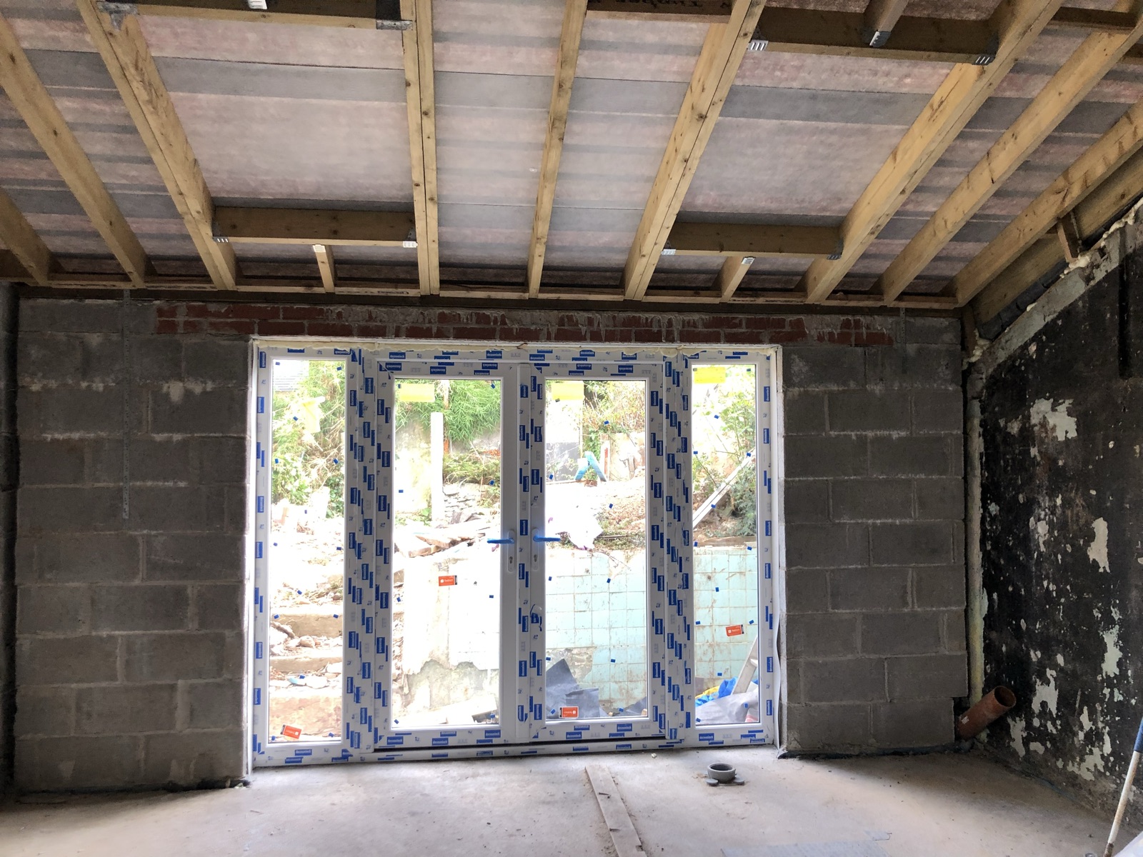 Glazed doors and roof framing during the kitchen renovation